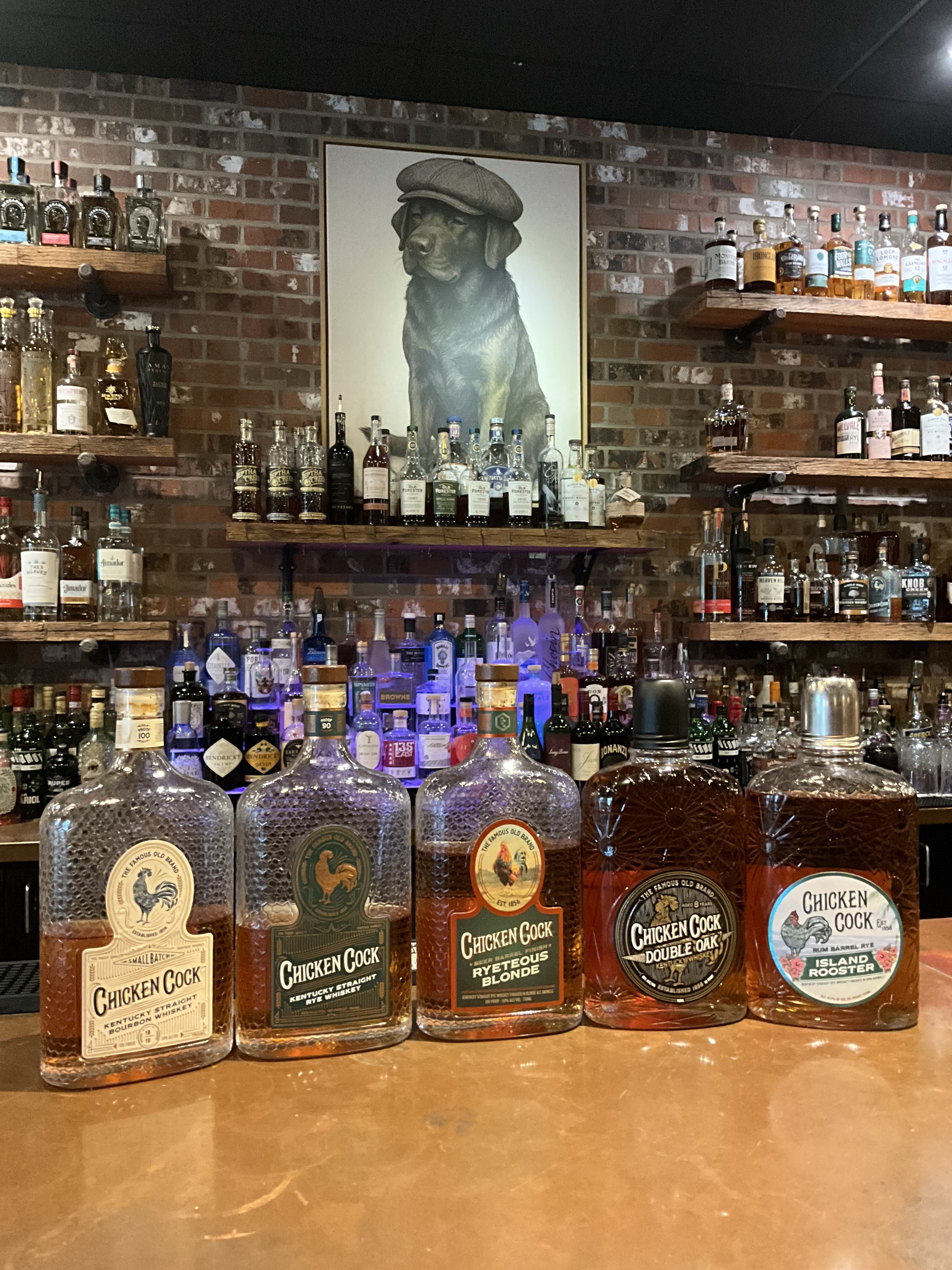 Five Chicken Cock whiskey bottles on the Echo's Reserve bar