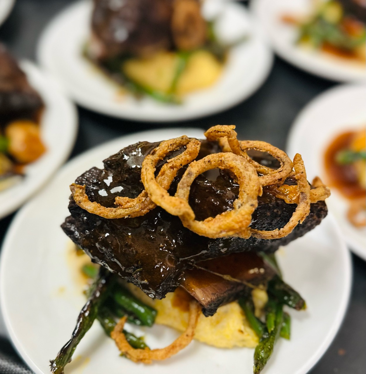 Braised beef topped with crisp onion rings